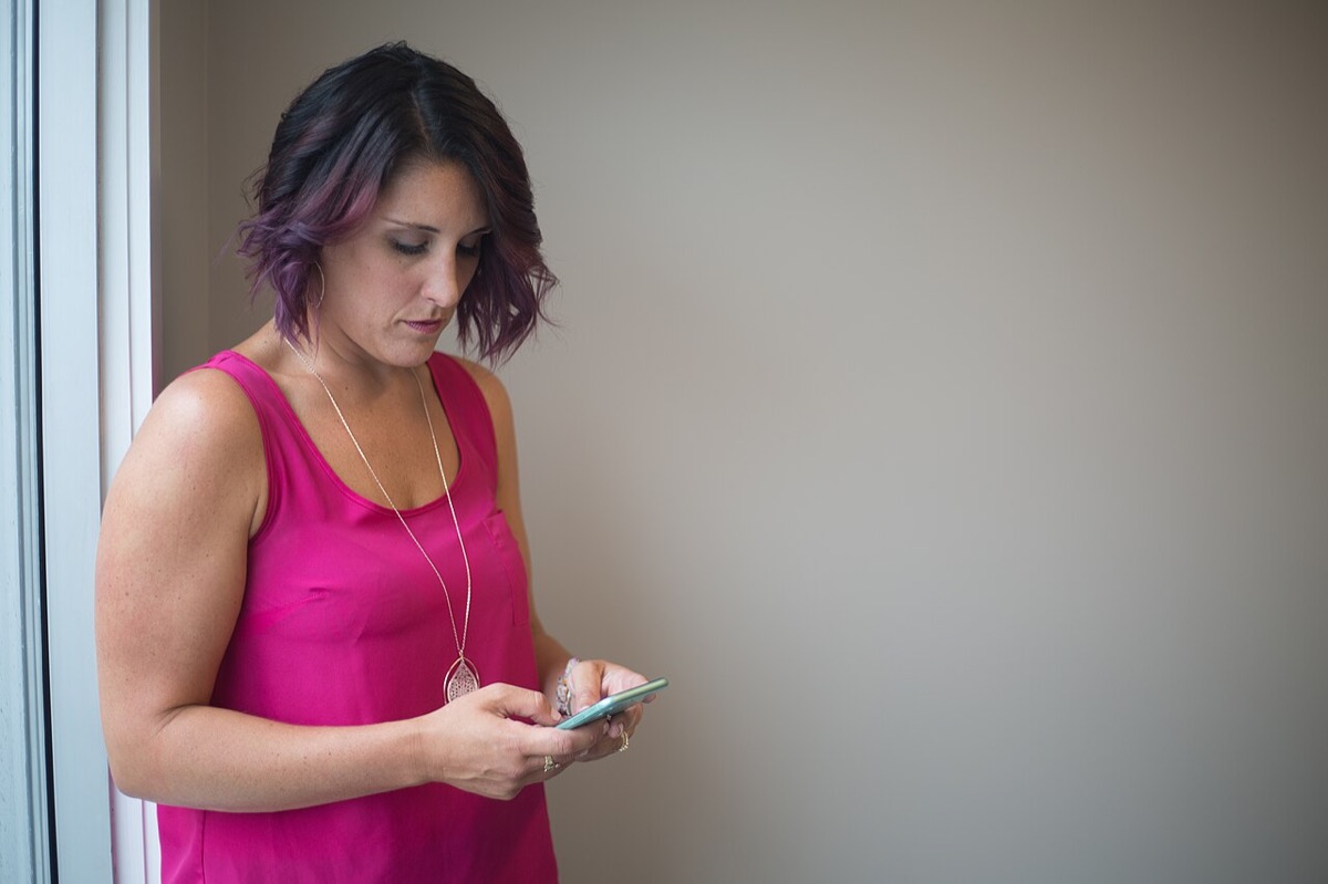 A person using a smartphone in a public place